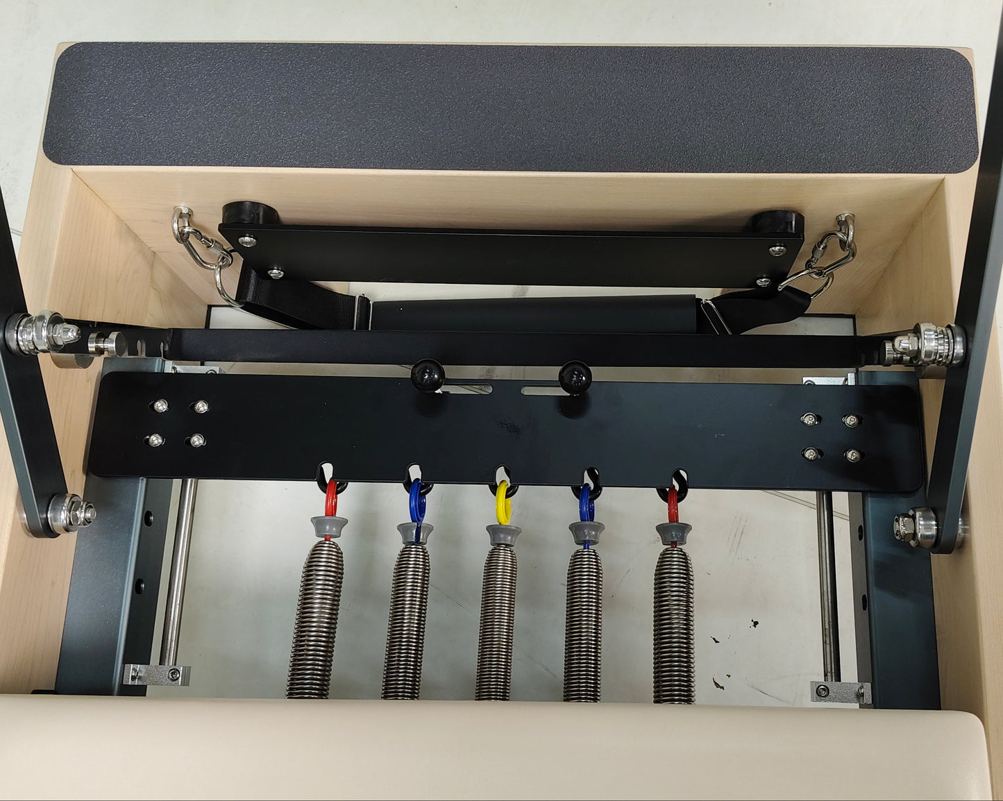 Gym equipment with resistance bands and pulleys on reformers pilates
