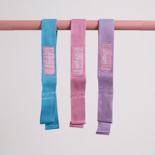 Three colourful lifting straps (blue, pink, purple) hanging on a pink barbell against a light grey background with freyja branding