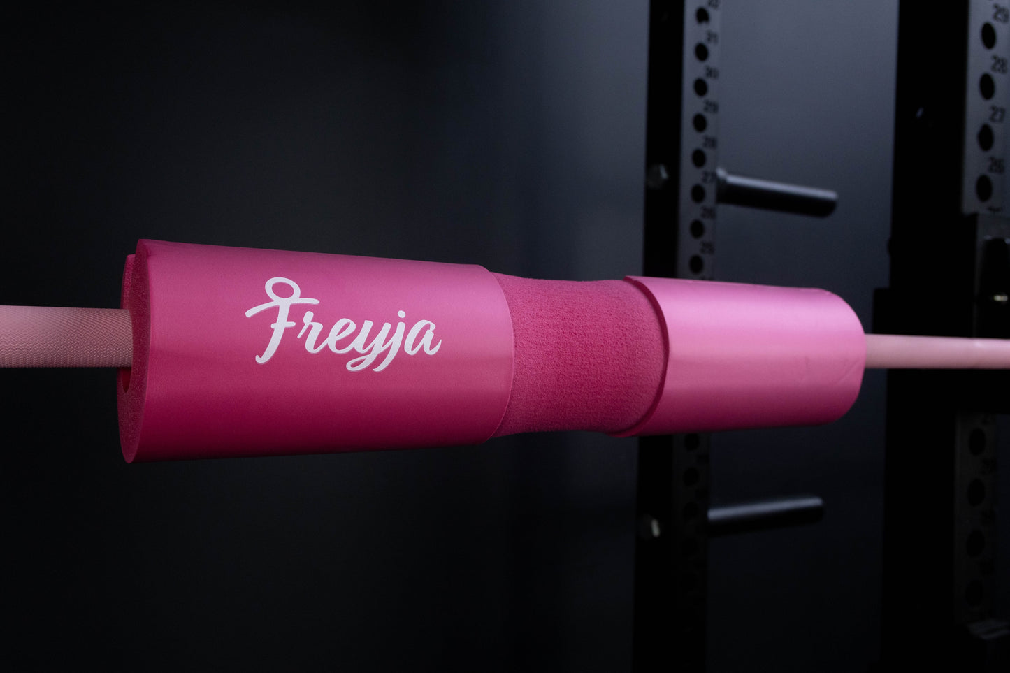 Pink freyja foam barbell on a pink barbell in a gym setting