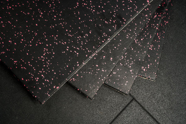 Black rubber mat with pink speckles on a black background