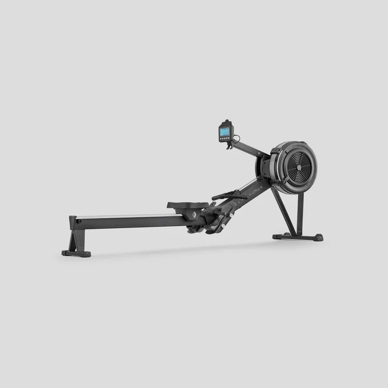 half human black rowing machine on a light grey background