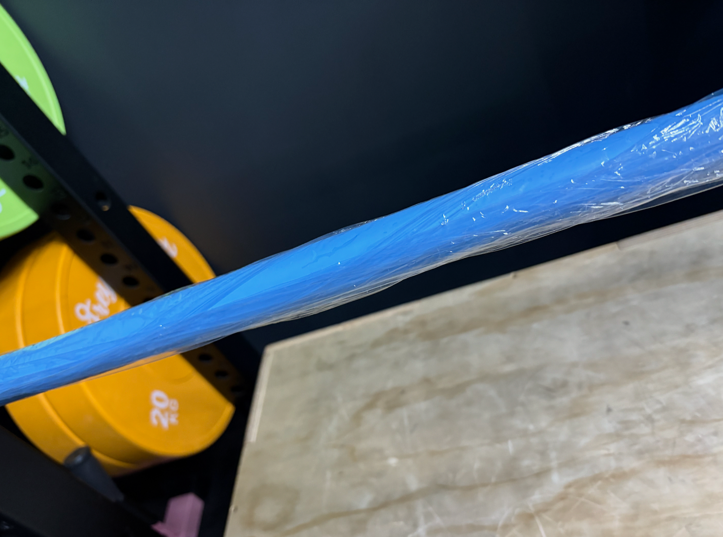 Blue 7.5kg technique barbell wrapped in plastic for women's weightlifting training and form improvement