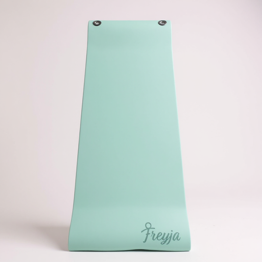 Green freyja branded yoga mat with eyelets on a white background