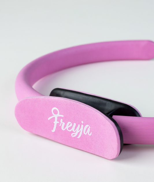 pink freyja pilates ring close up with branding on a white background