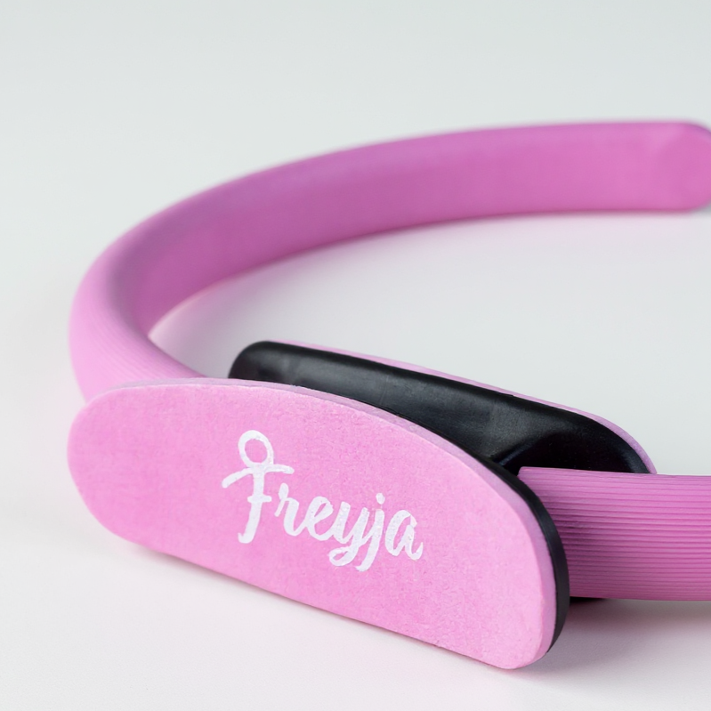 pink freyja pilates ring close up with branding on a white background