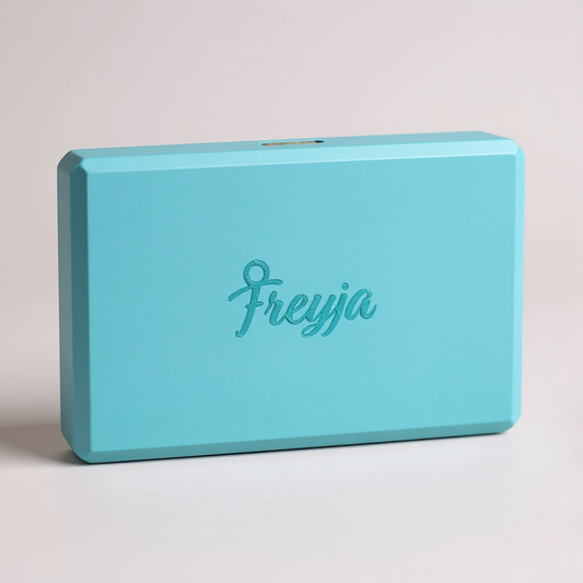 Blue Freyja yoga block with branding on white background