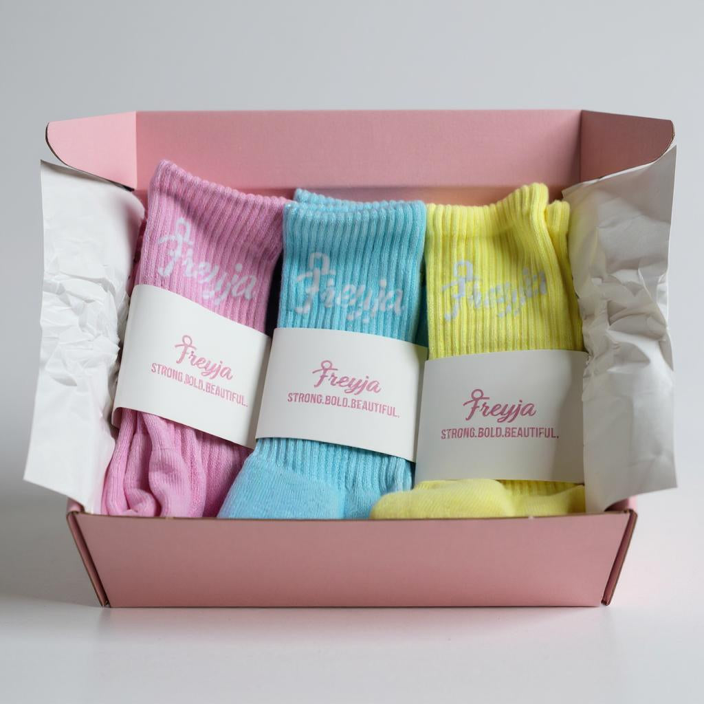 Three Set of colourful socks in a pink box with Freyja branding.