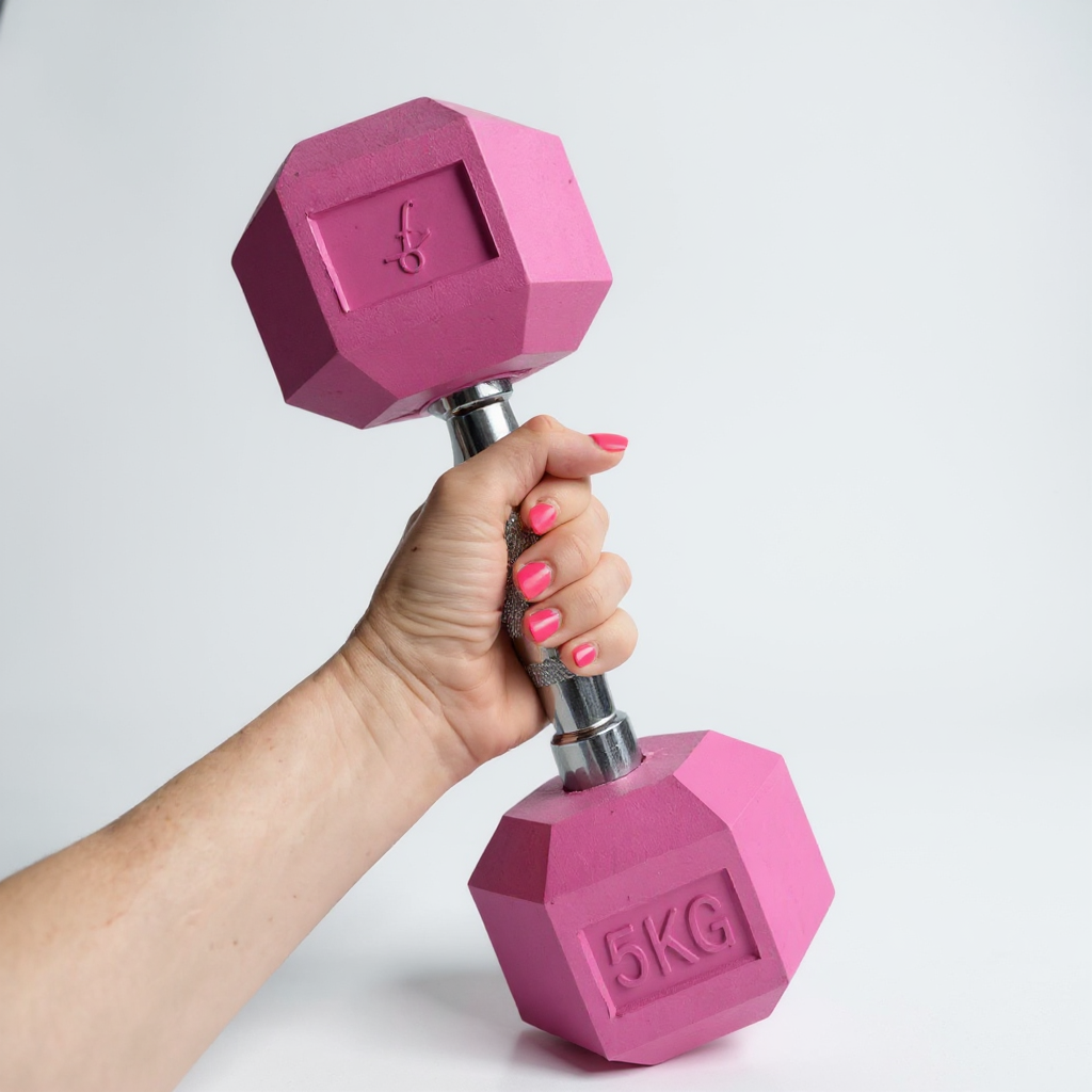 Hand holding a Freyja Fit pink 5KG dumbbell against a white background