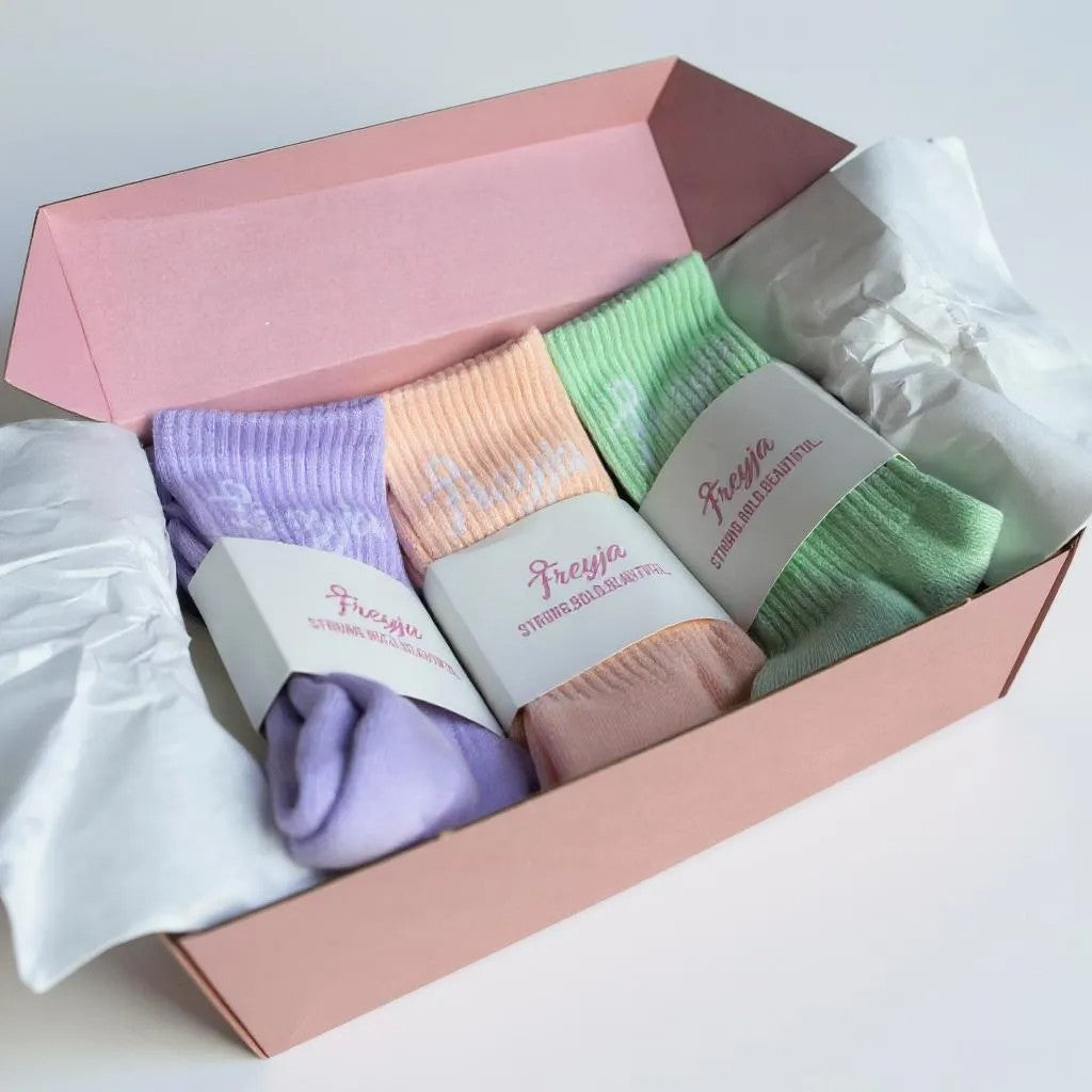 three Set of colourful socks in a pink box with Freya branding.
