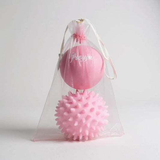 Freyja Fit pink massage ball set in a clear drawstring bag, displayed on a light grey background
