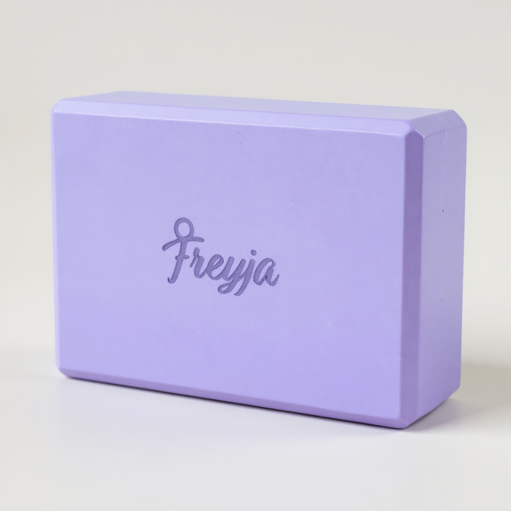 Purple Freyja yoga block with 'Freyja' branding on a light grey background