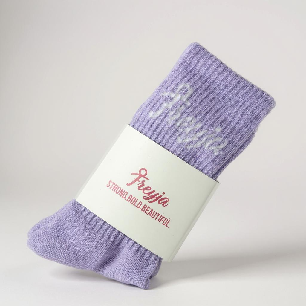 Purple freyja branded sock with a Freyja label on a light grey background