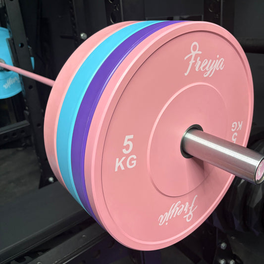 Pink weight plate with 'Freyja' branding on a barbell