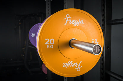 Orange Freyja Fit bumper plate on a barbell for gym and weightlifting