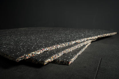 Three grey fleck flooring gym mats 