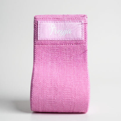 Pink resistance glute band with freyja branding on a white background