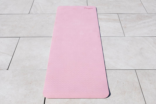 Pink Freyja yoga mat on a tiled floor
