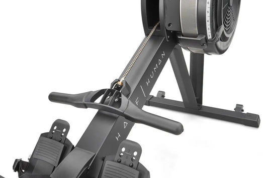 Close up of rowing machine with 'half human' branding on a white background
