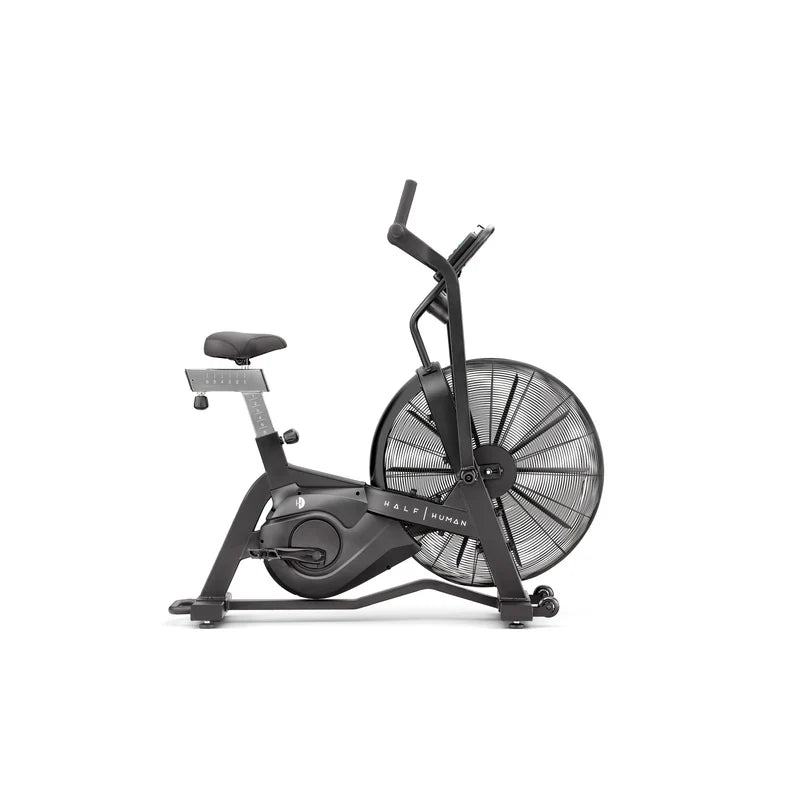 side view of black half human exercise bike on a white background 