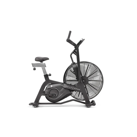 side view of black half human exercise bike on a white background 