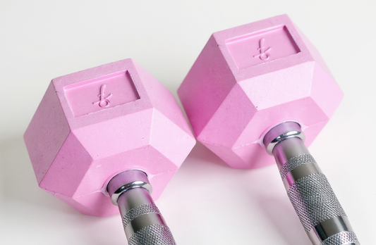 Two pink freyja hex dumbbells with chrome handles on a white background