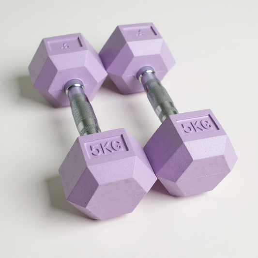 Pair of purple freyja hex dumbbells with '5kg' marking on a light grey background