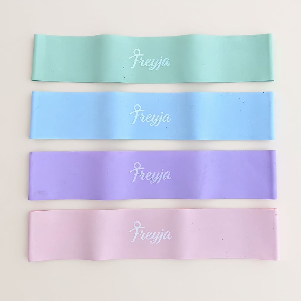 Four resistance bands in pastel colours with 'Freyja' branding on a light background