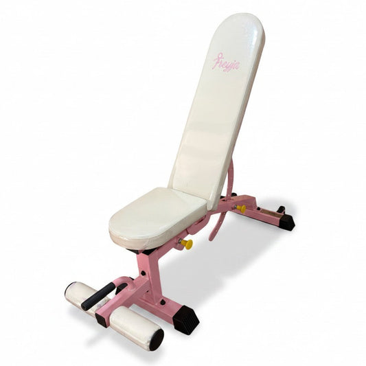 A pink and white adjustable weight bench with a padded backrest and seat, featuring a small pink Freyja logo on the headrest, shown on a white background.