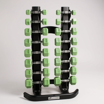 Recharge rack holding a set of green Freyja dumbbells on a grey background