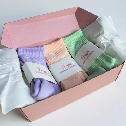 three Set of colourful socks in a pink box with Freya branding.