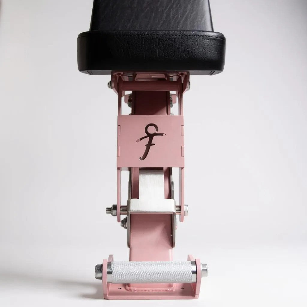 Close up of freyja branding on pink and black adjustable bench on a white background