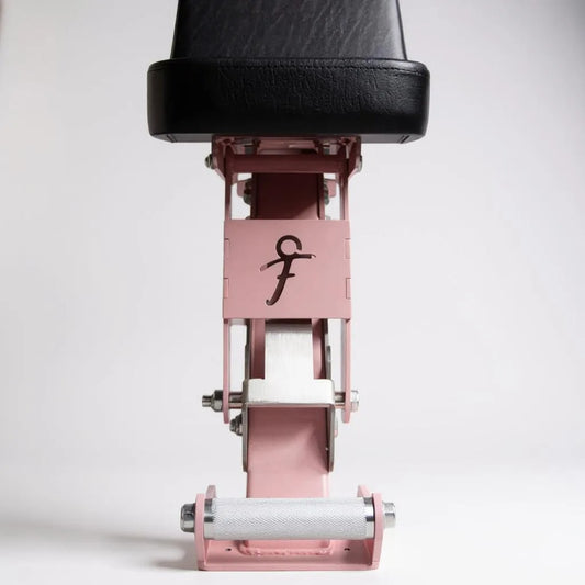 Close up of freyja branding on pink and black adjustable bench on a white background
