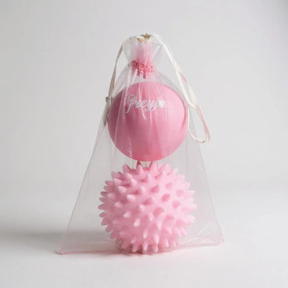 Freyja Fit pink massage ball set in a clear drawstring bag, displayed on a light grey background