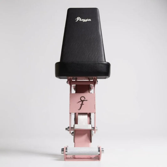 Black and pink adjustable weight bench with 'Freyja' branding on a white background