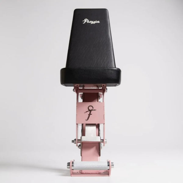 Black and pink adjustable weight bench with 'Freyja' branding on a white background