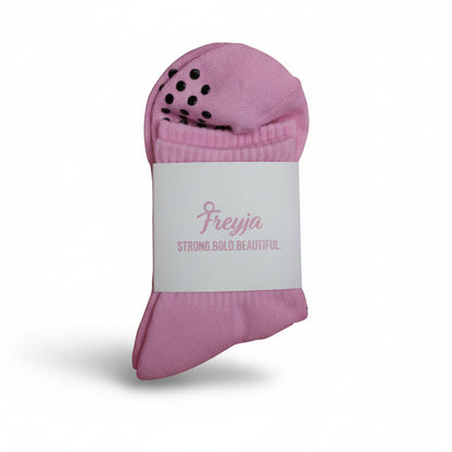 pink grip socks with Freyja branding on 