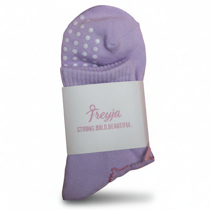 pastel purple grip socks with Freyja branding on 