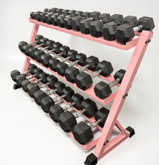 Set of black dumbbells on a pink metal dumbbell rack
