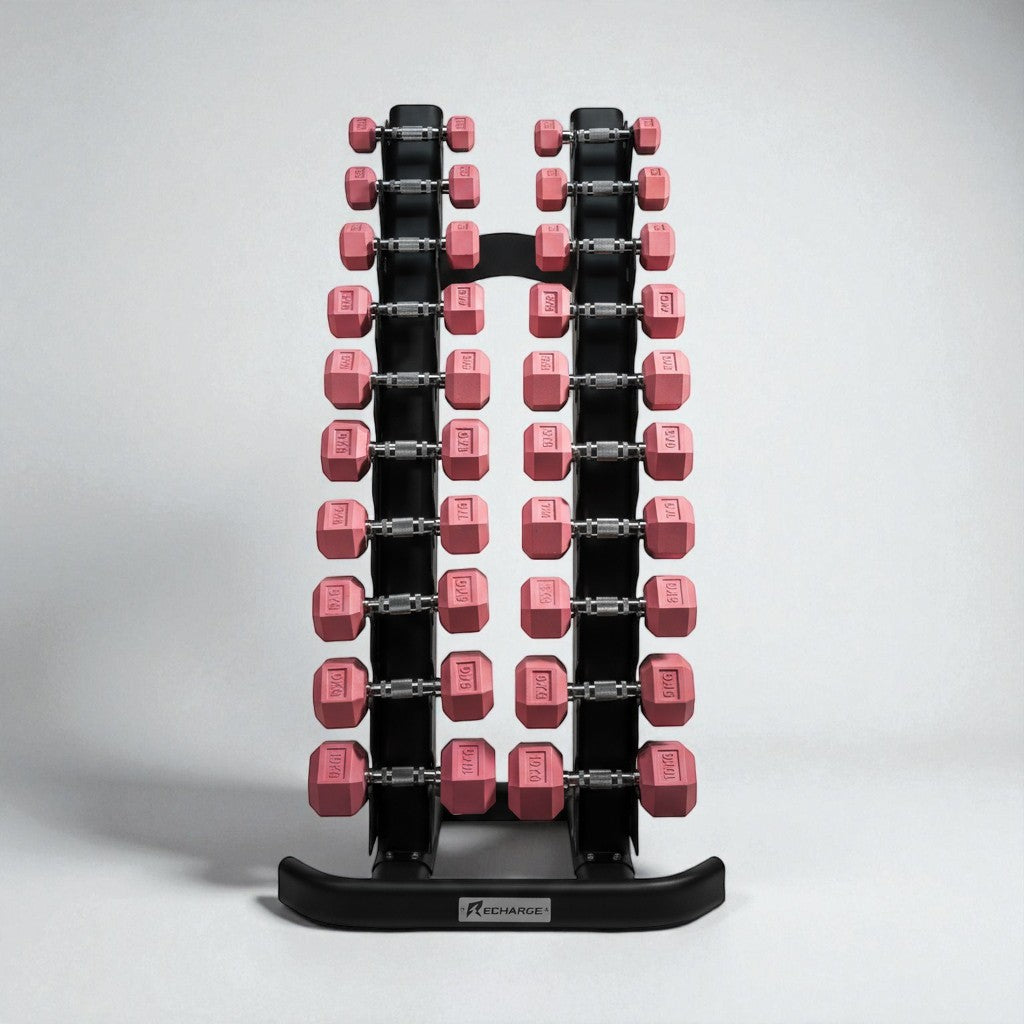Set of pink hex dumbbells from 1 to 10kg neatly organized on a black vertical dumbbell rack for home or gym use