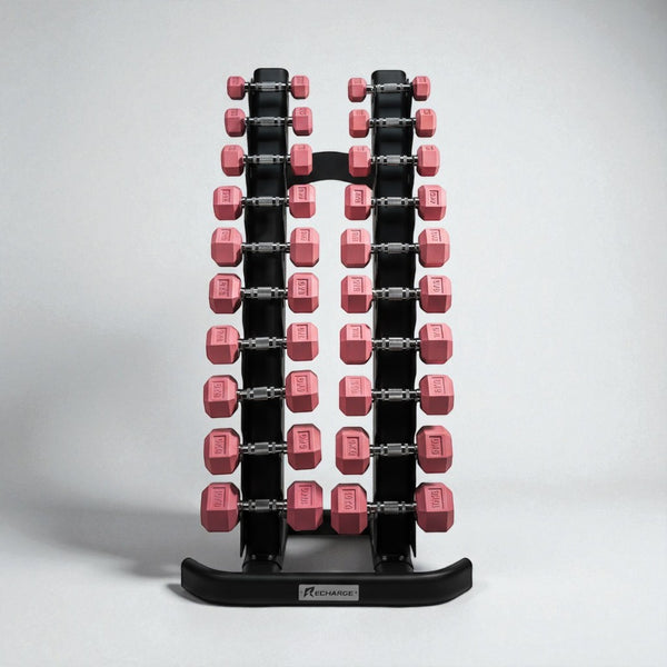 Set of pink hex dumbbells from 1 to 10kg neatly organized on a black vertical dumbbell rack for home or gym use