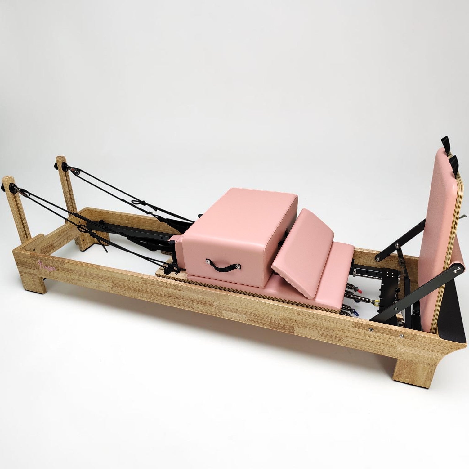 Pilates reformer with pink cushion 